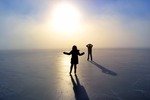 Iceskating couple on a frozen lake